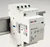 A white electrical relay device mounted on a metal rail. Produktbild-Vorschau