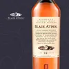 A bottle of Blair Athol 12 Years Flora & Fauna Scotch Whisky is shown against a dark blue background with floral illustrations. The label is prominently displayed. Produktbild-Vorschau