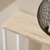 A close-up shot of a wooden table with white legs and a black decorative object on top. Anteprima dell’immagine prodotto