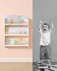 A split image showing a bookshelf with children's books on the left and a crying child with a pile of books on the right. Náhled obrázku produktu
