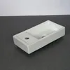 A white ceramic sink is shown on a dark gray countertop against a white background. Podgląd zdjęcia produktu