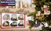 A set of wooden Christmas tree ornaments in a box, with some ornaments hanging on a Christmas tree. Náhľad obrázku produktu