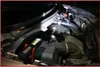 A work light is illuminating the engine bay of a car. Podgląd zdjęcia produktu