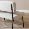 Close-up view of the back of a bench with black metal legs. Produktbild-Vorschau