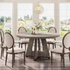 A dining room set with a round table and chairs, set against a backdrop of large windows overlooking a suburban landscape. Anteprima dell’immagine prodotto
