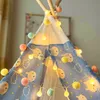 A close-up view of a child's teepee decorated with a string of colorful pom-pom lights. Náhľad obrázku produktu