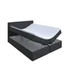A black upholstered bed frame with a mattress and topper, shown with the storage compartments open. Produktbild-Vorschau