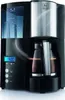 A black Melitta Optima Timer coffee maker with a silver accent on a light gray background. Produktbild-Vorschau