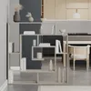 A modern living room or dining area with a bookshelf room divider. Produktbild-Vorschau