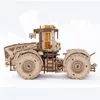 A 3D wooden model of a tractor is shown in a studio setting against a white background. Produktbild-Vorschau