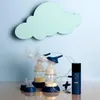 A light blue wall with a light green cloud decoration above a double electric breast pump set. Podgląd zdjęcia produktu