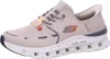 A side view of a beige Skechers sneaker. Voir les images du produit