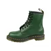 A single green Dr. Martens boot is shown against a white background. Produktbild-Vorschau
