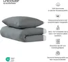 A folded duvet and pillow in dark gray, with accompanying product feature icons and text. Produktbild-Vorschau