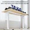 A white adjustable standing desk with a wooden top is shown with weights on it. Podgląd zdjęcia produktu