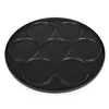 A black round griddle with seven circular indentations, photographed from a slightly elevated angle against a white background. Náhľad obrázku produktu