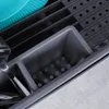 A close-up view of a grey dish rack with cutlery and a teal plate inside. Produktbild-Vorschau