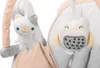 Close-up of two plush toys hanging from a baby swing or chair. Produktbild-Vorschau