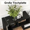 A black TV stand with decorative items on top, including a vase of flowers and picture frames. Dimensions are indicated on the stand. Voir les images du produit
