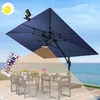 An outdoor patio scene with a large umbrella, table, and chairs, with the ocean in the background. Anteprima dell’immagine prodotto
