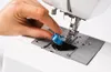 A hand is placing a bobbin on a sewing machine. Anteprima dell’immagine prodotto
