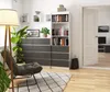 A minimalist living room or office space with a bookshelf, chest of drawers, and a chair. Produktbild-Vorschau