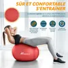 A woman is doing sit-ups on a red exercise ball in a bright room. Produktbild-Vorschau