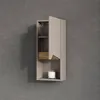 A wall-mounted bathroom cabinet with a door and open shelves, against a textured gray wall. Produktbild-Vorschau