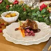 A festive Christmas table setting with a plate of food. Produktbild-Vorschau