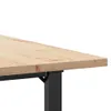 A close-up view of the corner of a wooden table with a black metal leg. Anteprima dell’immagine prodotto