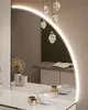 A reflection of a vanity area with a sink, faucets, and a decorative partition wall. Produktbild-Vorschau