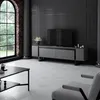 A modern living room with a TV stand, coffee table, and armchair. Voir les images du produit