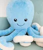 A close-up of a large, blue plush octopus toy sitting on a light blue chair. Anteprima dell’immagine prodotto
