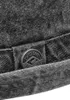 A close-up of a button on a gray fabric item. Produktbild-Vorschau