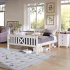 A bedroom scene with a white wooden bed, nightstand, and rug. Náhľad obrázku produktu