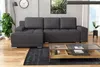 A modern living room with a sectional sofa, coffee table, and plants. Produktbild-Vorschau