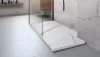 A modern bathroom with a shower tray and marble-tiled walls. Náhled obrázku produktu