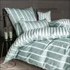 A neatly made bed with striped bedding and pillows. Produktbild-Vorschau