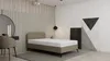A bedroom scene with a bed, vanity, and abstract art. Produktbild-Vorschau