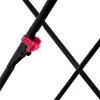 A close-up of a black metal frame with a red clip holding two parts together. Produktbild-Vorschau