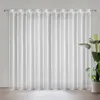A white sheer curtain hanging on a rod in front of a window. A potted plant is visible to the right. Voir les images du produit