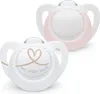 Two NUK pacifiers are shown against a white background. One pacifier is in the foreground and has a heart design and text. The other pacifier is in the background and is pink. Voir les images du produit