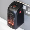 A black plug-in electric heater is shown plugged into a wall socket. Anteprima dell’immagine prodotto