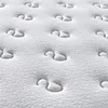 A close-up, textured view of a white mattress surface with tufted buttons. Produktbild-Vorschau