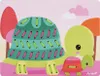 A cartoon illustration of two turtles, one large and one small, with colorful patterns on their shells. Produktbild-Vorschau