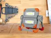 A work light and a set of wrenches are displayed on a wooden workbench. Produktbild-Vorschau