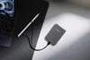 A gray power bank is connected to a laptop with a stylus nearby, all on a desk. Produktbild-Vorschau