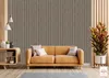 A living room scene with a couch, side table, and plant against a slatted wall. Anteprima dell’immagine prodotto