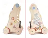 A wooden baby walker with various educational toys and activities. Voir les images du produit