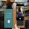 A woman is holding a phone case with a phone inside, showing a picture of herself. Voir les images du produit